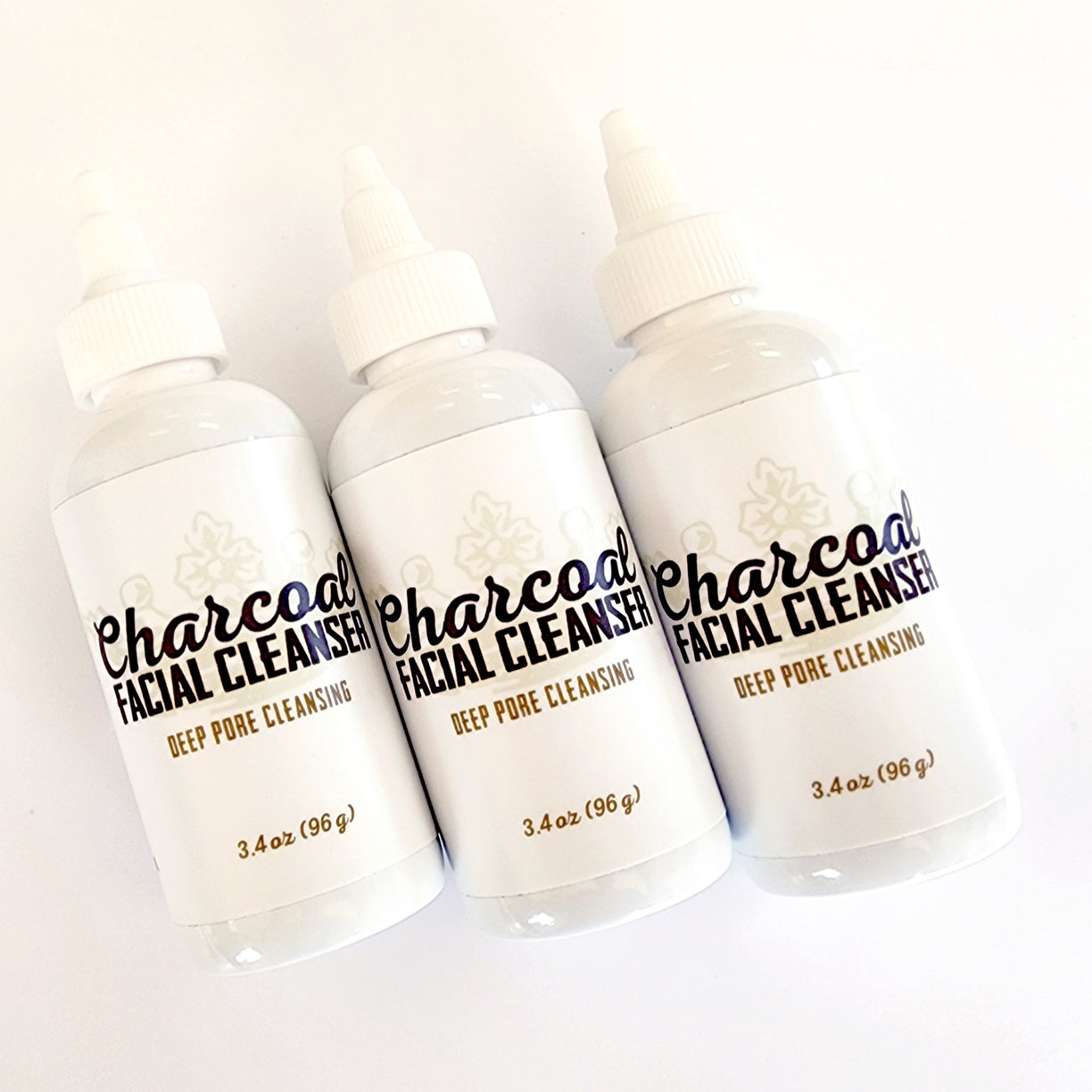 Three Charcoal Facial Cleanser 3.4 oz bottles, angled