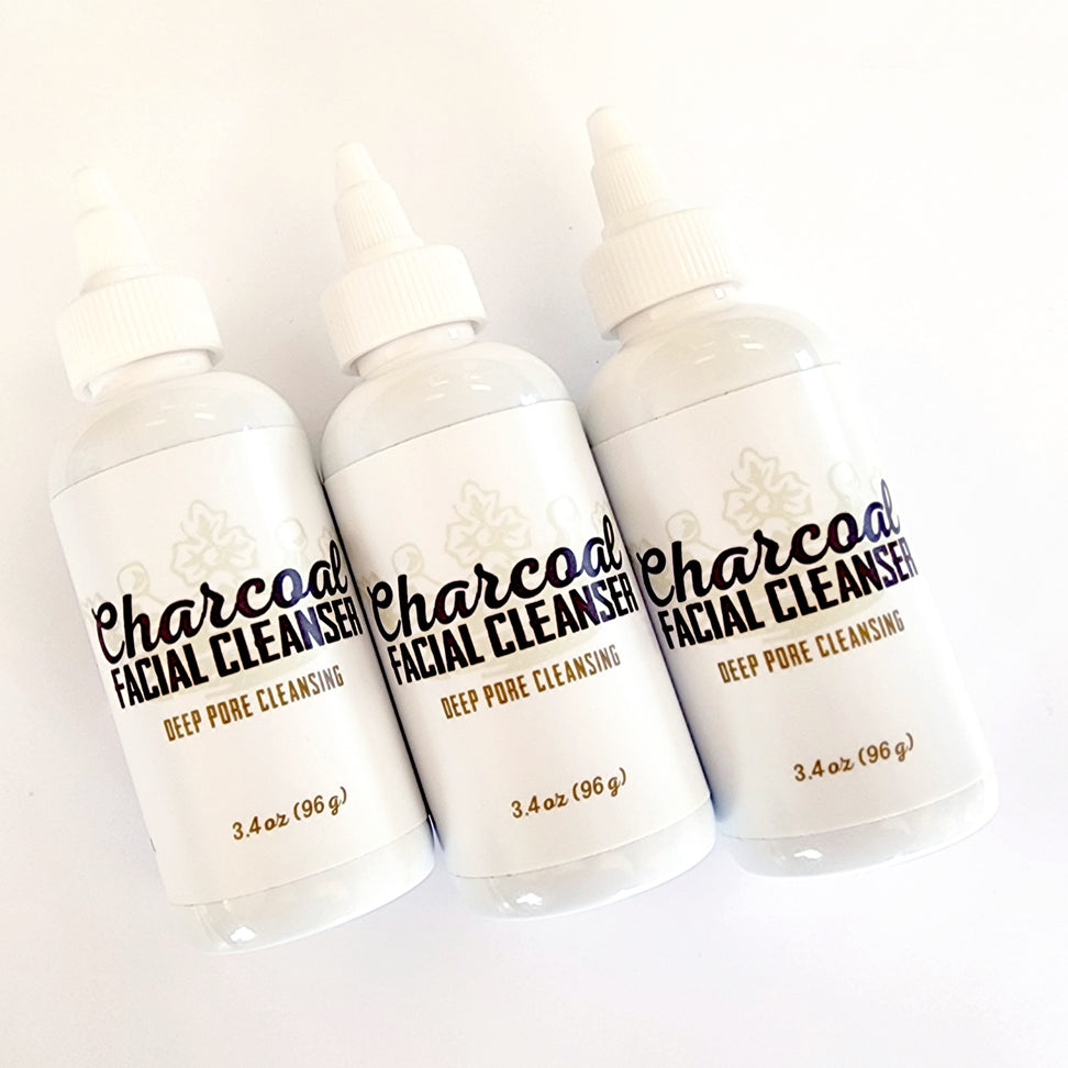 Three Charcoal Facial Cleanser 3.4 oz bottles, angled
